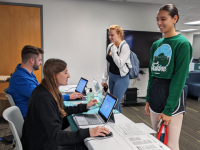 Two nurses checking in students at a flu clinic Two nurses checking in students at a flu clinic